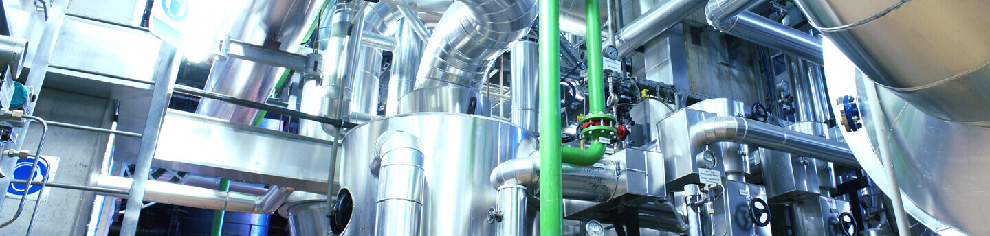 Equipment, cables and pipework in an industrial power plant.