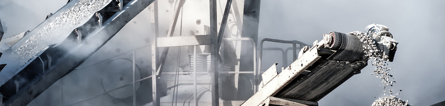 A cement production plant in a quarry. A conveyor belt with stones and gravel.